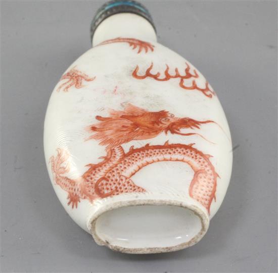 A Chinese iron red enamelled dragon snuff bottle, 19th century, height 7.6cm excl. coral and enamelled silver stopper